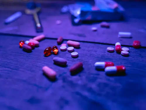Prescription pills on floor at night