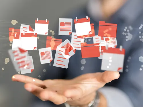 a hand holding floating calendar icons