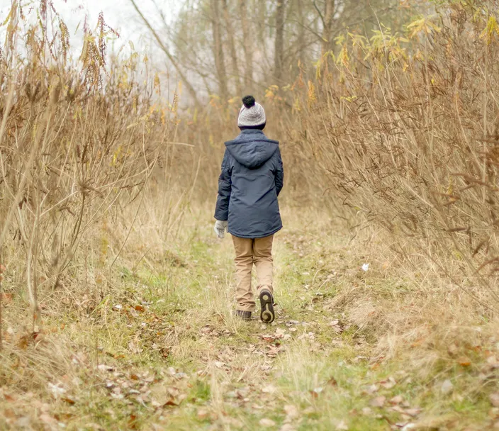 child walking alone in field