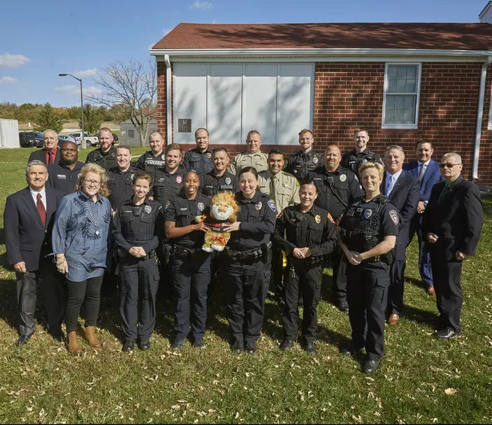 Police officers pose with DARE tiger